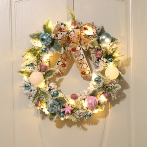 Flocked Christmas wreath with colorful ornaments, snowman bow, and warm LED lights