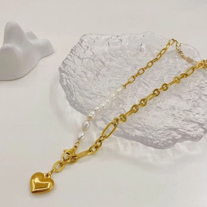 Detail of 14K gold stainless steel chain with freshwater pearls and heart pendant