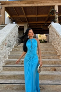 Detail of blue halter dress with side drawstring ruching and flowing pleated fabric