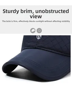 Detail of dark blue quilted baseball cap featuring reinforced visor and shield embroidery