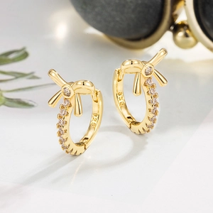 Detailed macro view of 925 sterling silver bow earrings with white zircon stones