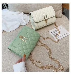 Quilted crossbody bags in mint green and ivory with gold metal chain and Y-lock detail
