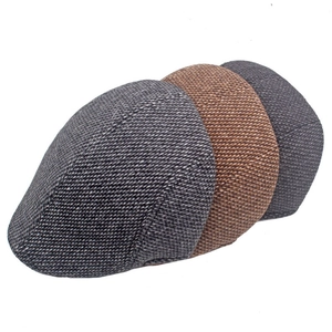 Detailed texture of men's winter wool flat caps in grey, coffee, and charcoal tones