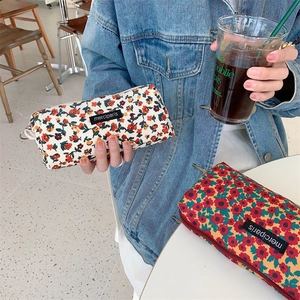Detailed texture of corduroy floral pencil case with vintage pattern and metal zipper