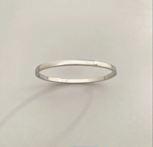 Detailed view of silver minimalist titanium steel bracelet with a polished finish surface