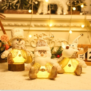 Cozy Christmas scene with glowing Santa, snowman, and reindeer plush LED decorations
