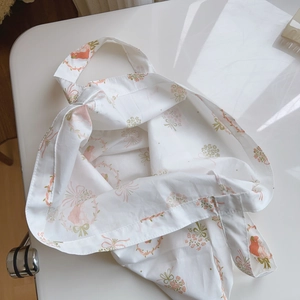 Detail of French style floral cotton tote bag with pink vintage girl and ribbon patterns