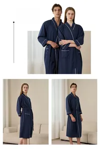 Detail of dark blue waffle bathrobe with contrast piping and kimono collar design