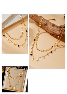 Macro detail of a layered gold chain necklace featuring colorful beads and star charms