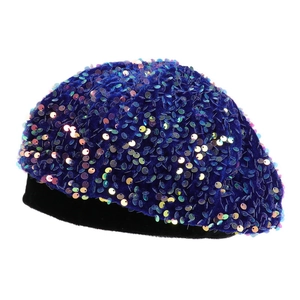 Detailed view of blue velvet beret featuring colorful shimmering sequins on white background