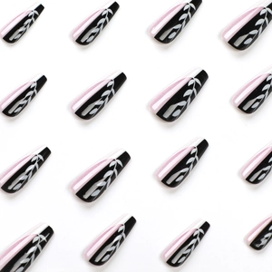 Pink and black French press on nails with white leaf pattern in long coffin shape