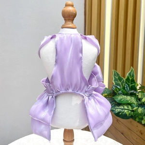 Detail view of lavender purple pet dress with layered organza skirt on wooden stand