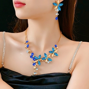 Detail of vintage flower jewelry set with blue crystals worn by a female model