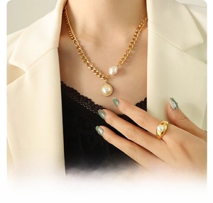 Detail of 18k gold plated surgical titanium steel necklace with elegant pearl pendant