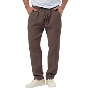 Detail of brown cotton linen casual trousers featuring an elastic drawstring waistband