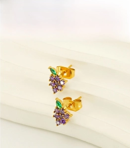 Detail view of gold stainless steel grape stud earrings with purple and green zircon