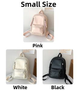 Detail view of small faux leather backpacks in pink, white, and black with braided zippers