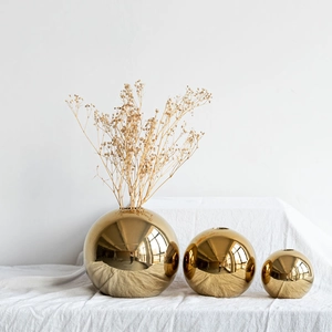 Three gold electroplated ceramic sphere vases with dried flowers for home decor