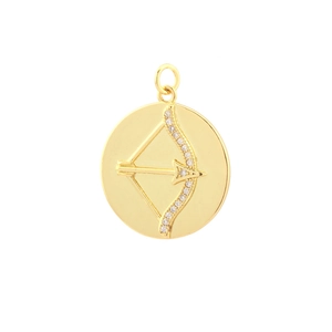 Macro detail of gold-plated cupid arrow pendant with sparkling zircon inlays
