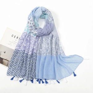 Close-up of cotton linen scarf featuring multi-pattern stitching and blue tassel fringes