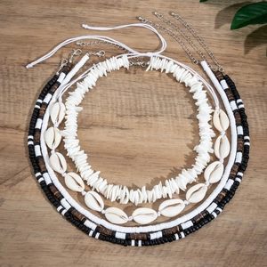 Bohemian multilayer shell and wood bead necklace set for men on a natural wooden background