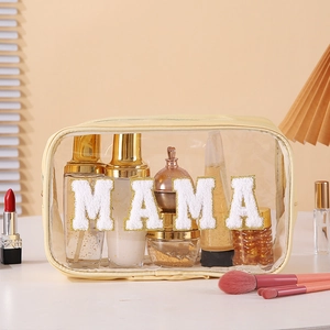 Detail of waterproof PVC toiletry bag with MAMA chenille letters on a vanity table