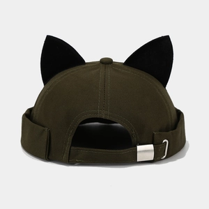 Detail of dark green docker hat featuring cat ears and silver metal adjustable buckle