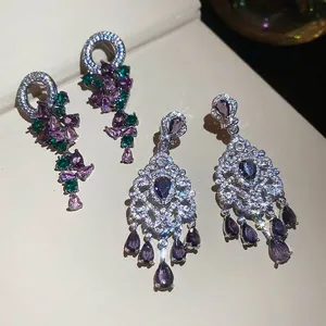 Elegant drop earrings with purple crystals and pear-shaped stones on silver base