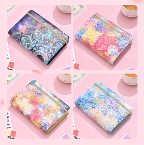 Detail view of four A6 mandala pattern PU leather planners with elastic closures