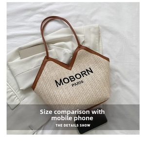 Straw tote bag size comparison with smartphone showing the spacious interior