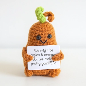 Handmade crochet pear plush doll with positive quote card on clean white background
