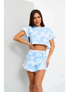 Dettaglio pigiama tie-dye blu e bianco con bordi a balze ed elastico in vita