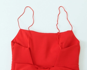 Close-up of red mini dress showing square neckline and thin spaghetti straps detail