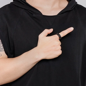 Close-up of men's matte black titanium steel Cuban chain ring worn on finger