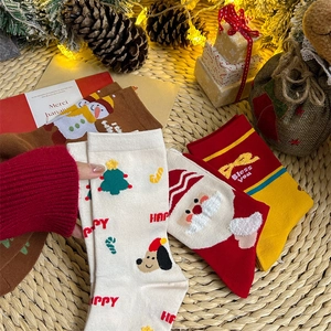 Detailed flat lay of festive cotton Christmas socks with Santa and reindeer motifs