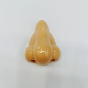 Detail view of the realistic nose-shaped manual pencil sharpener in skin-tone finish
