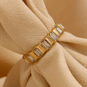 Close-up of gold-plated stainless steel ring with baguette-cut cubic zirconia stones