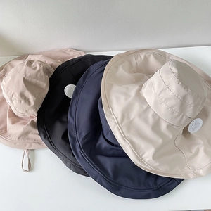 Close-up of lightweight wide-brim sun hats in four colors with UPF protection tags