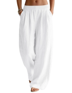 Detail of white linen wide-leg trousers showing elastic waistband and functional pockets