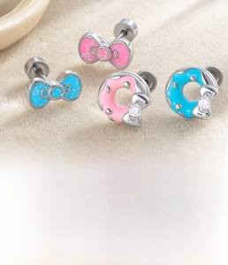 Macro detail of bow-knot donut earring set featuring titanium steel and cubic zirconia