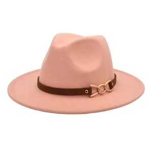 Pink wool fedora hat detail featuring a brown leather band and gold metal buckle accent