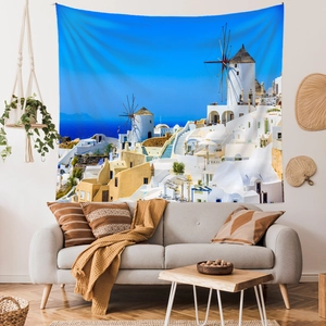 Detail view of Santorini landscape tapestry hanging above a modern living room sofa