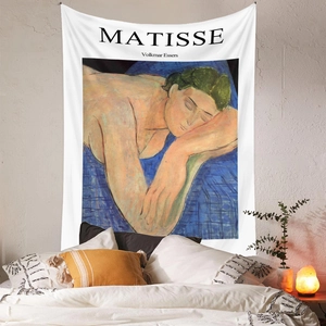 Detail of Matisse art tapestry hanging in a cozy bedroom with warm ambient lighting