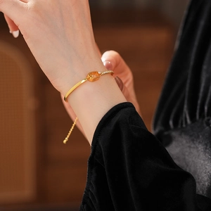 Close-up of 18k gold plated chain bracelet with sparkling zircon inlay on woman wrist