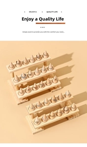 Detail of multi-tier wooden ring display stand with conical holders for jewelry showcasing