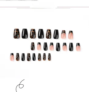 Detailed view of leopard print and French black tip press-on nails in coffin shape