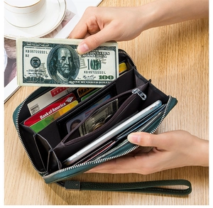 Detailed interior of green pebble grain leather wallet with multiple card slots and phone pocket