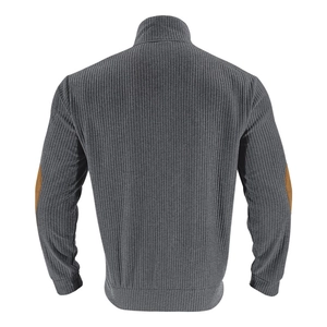 Detail of grey ribbed sweatshirt featuring brown suede elbow patches and textured knit fabric