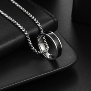 Polished silver stainless steel ring with black inlay on a round box chain necklace