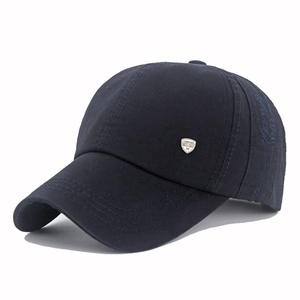 Detailed close-up of dark blue cotton baseball cap with silver metal fashion emblem
